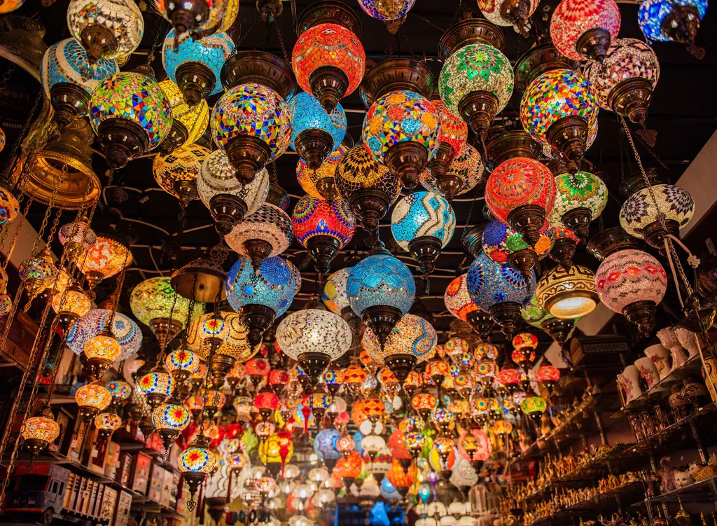 A ceiling hung with dozens of glowing mosaic lanterns