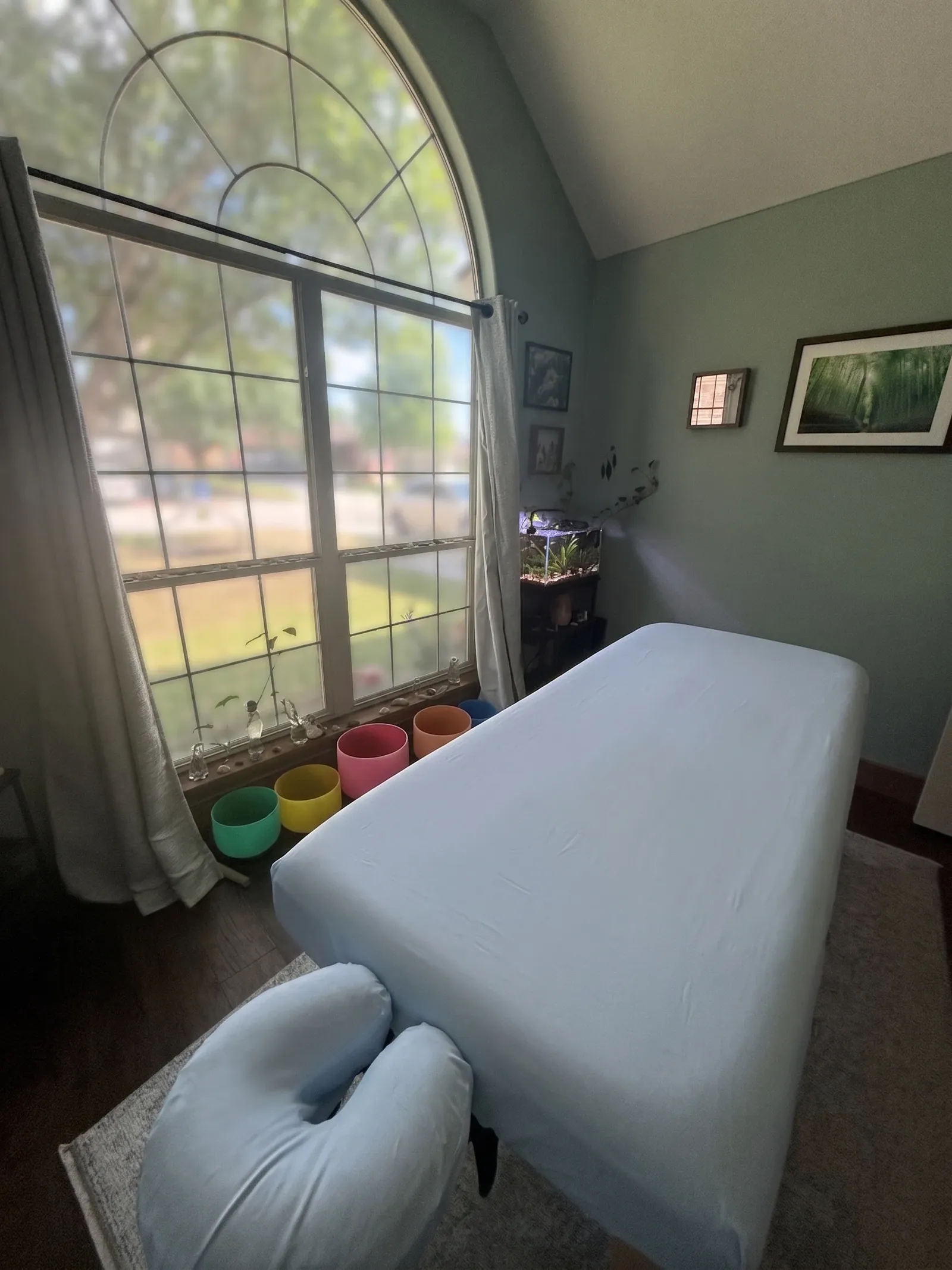 The Kitsune Healing studio with a massage table under an arched window